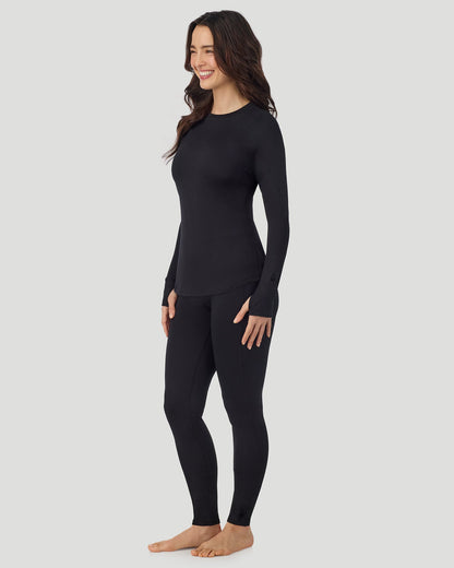 A lady wearing Thermawear Long Sleeve Raglan Crew in black shown in a front view standing pose