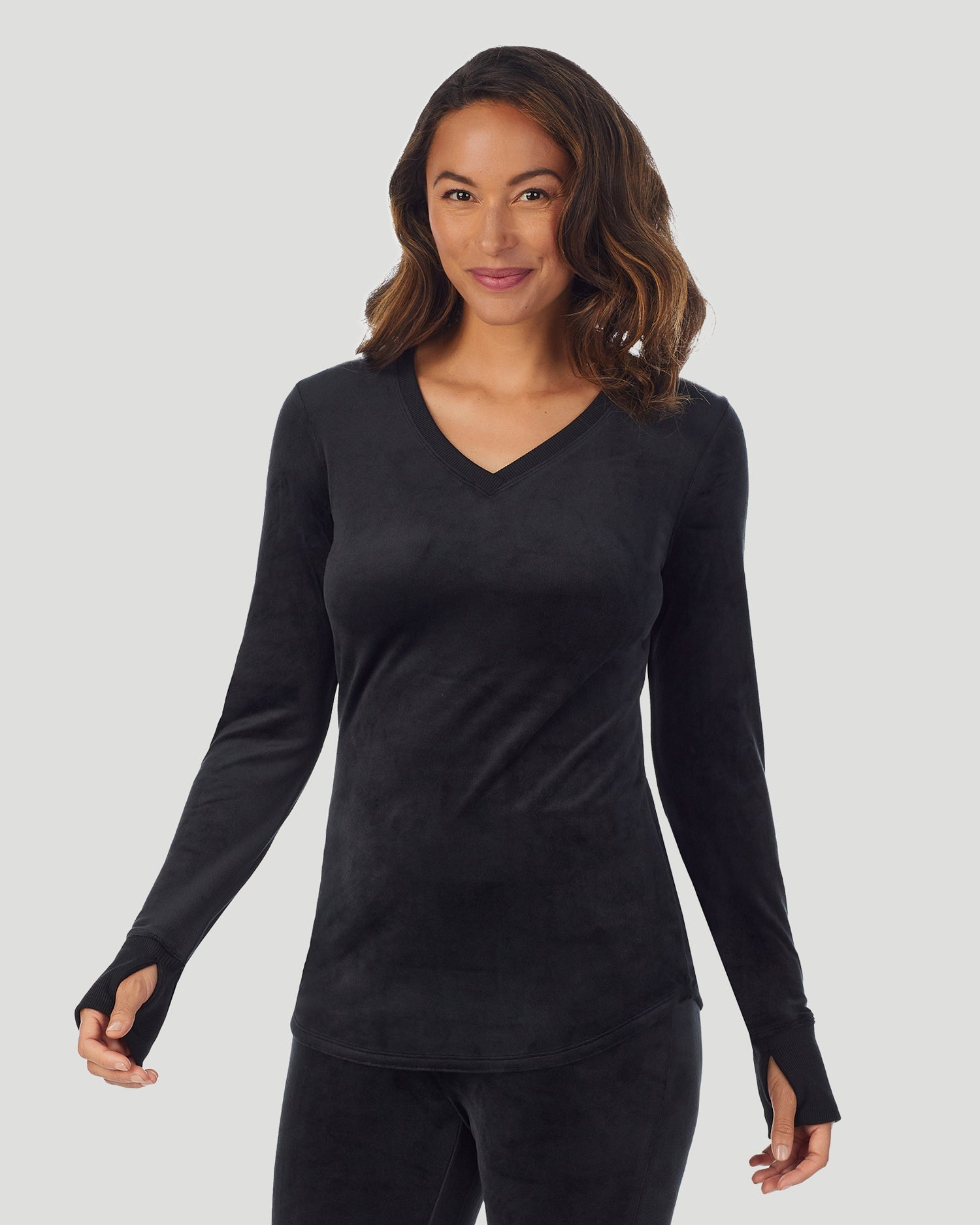 A lady wearing Stretch Velour Long Sleeve V-Neck in black shown in a front view pose