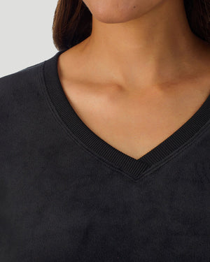 A lady wearing Stretch Velour Long Sleeve V-Neck in black shown in a front view detail close up shot