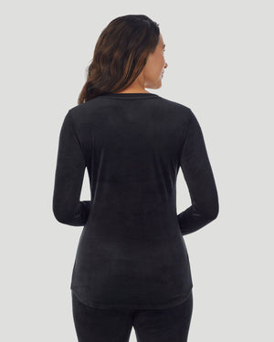 A lady wearing Stretch Velour Long Sleeve V-Neck in black shown in a back view pose