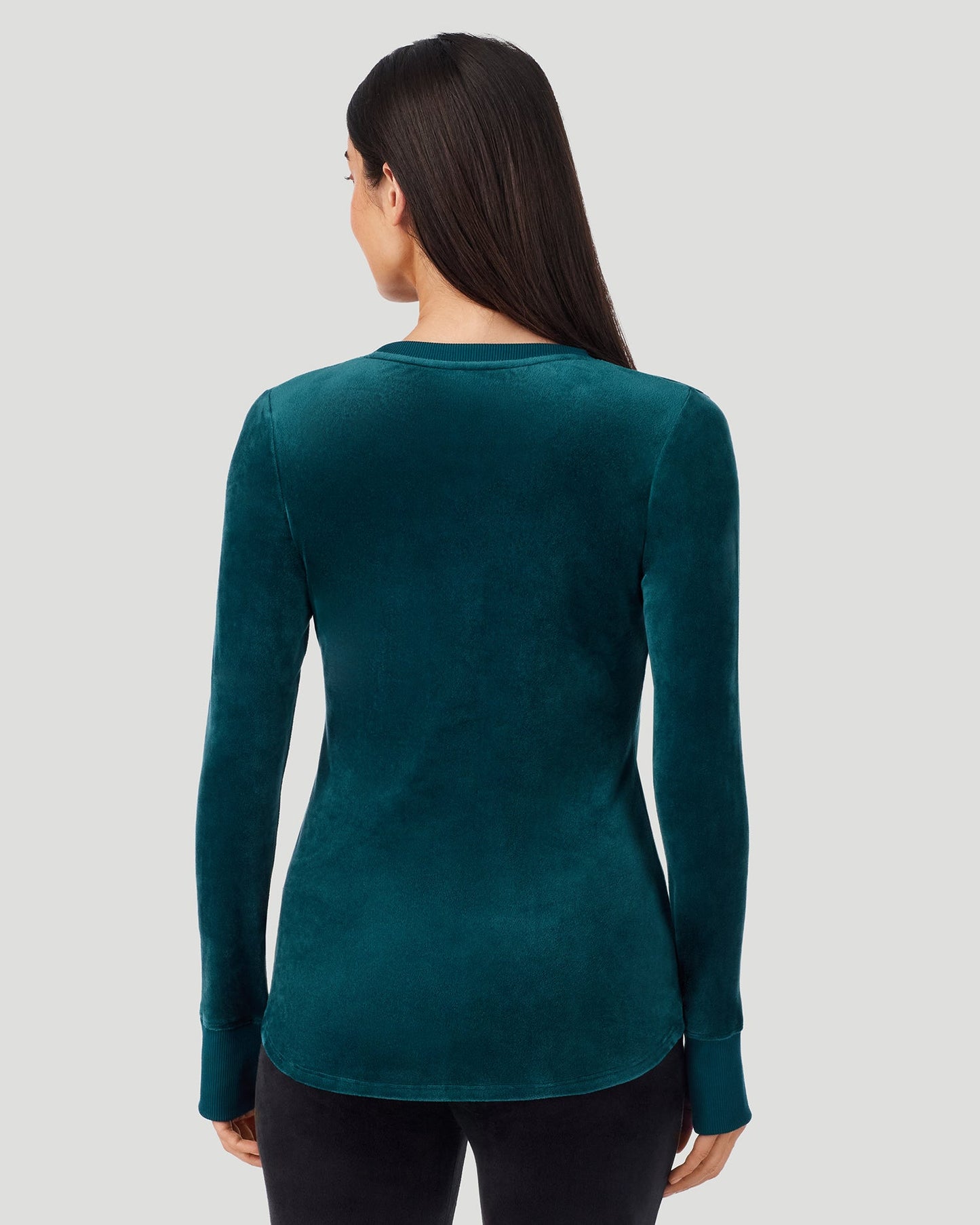 Deep Emerald; Model is wearing a size S. She is 5’9”, Bust 34.5”, Waist 25”, Hips 36.5”. @A lady wearing Stretch Velour Long Sleeve V-Neck in deep emerald shown in a back view pose