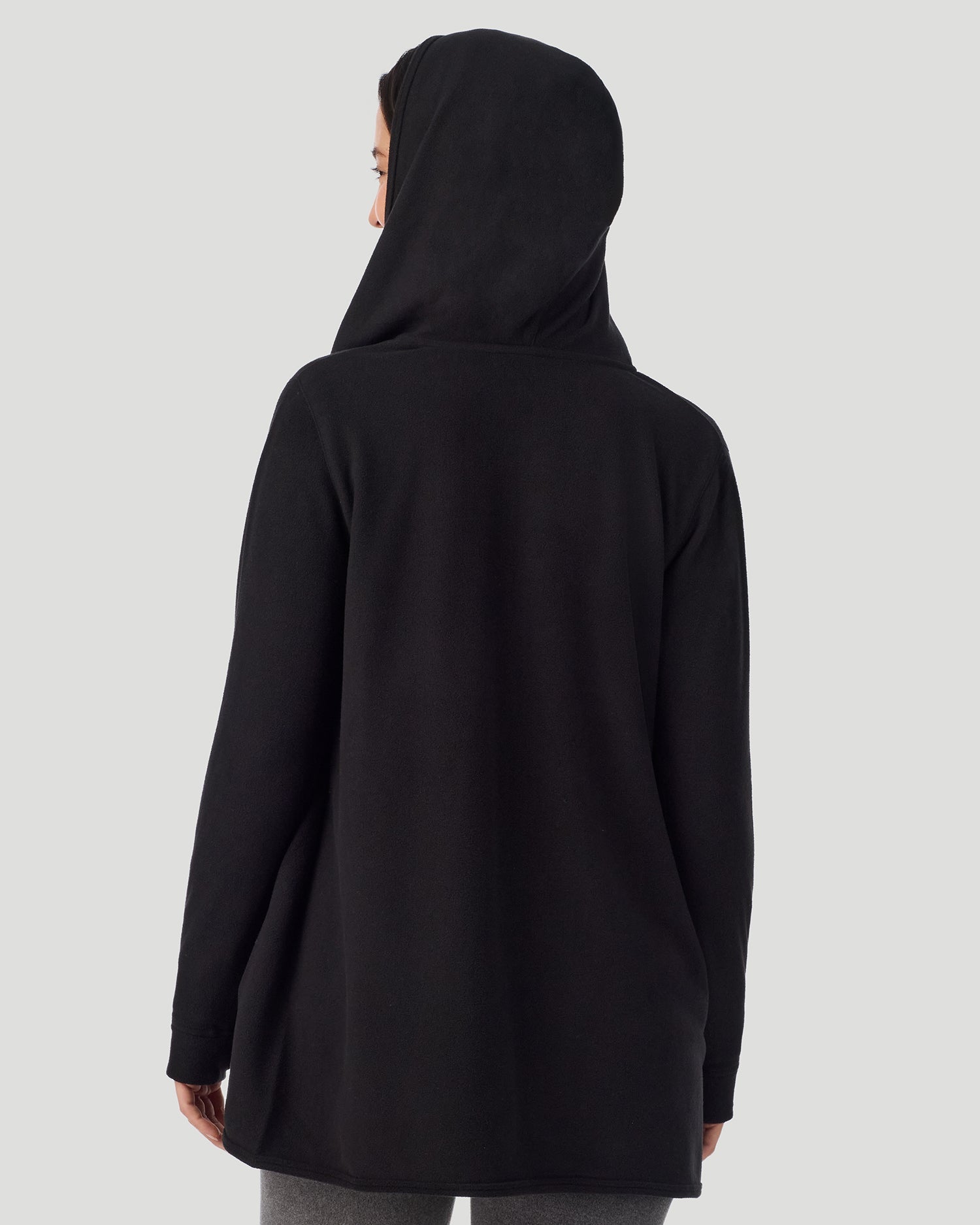 Black; Model is wearing a size S. She is 5’9.5”, Bust 34”, Waist 25”, Hips 36.5”. @ A lady wearing Fleecewear with Stretch Long Sleeve Wrap With Hood black closer look