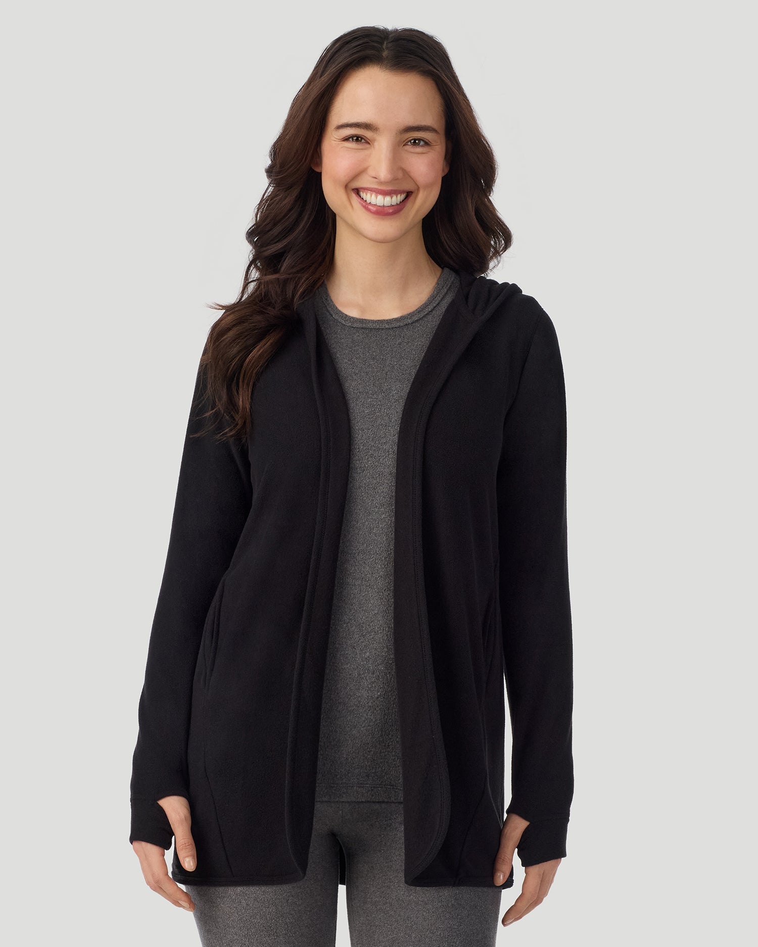 Black; Model is wearing a size S. She is 5’9.5”, Bust 34”, Waist 25”, Hips 36.5”. @ A lady wearing Fleecewear with Stretch Long Sleeve Wrap With Hood black closer look