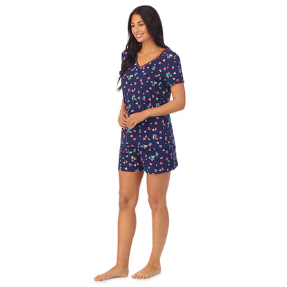 Strawberry Field; Model is wearing size S. She is 5'8.5", Bust 32", Waist 25", Hips 36". @ A lady wearing blue short sleeve top with boxer short pajama set with Strawberry Field print