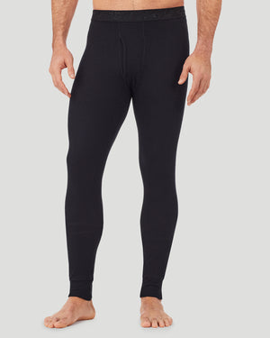 A man wearing a black waffle thermal pant.