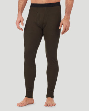 A man wearing a olive green waffle thermal pant.