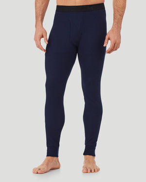 A man wearing a navy waffle thermal pant.