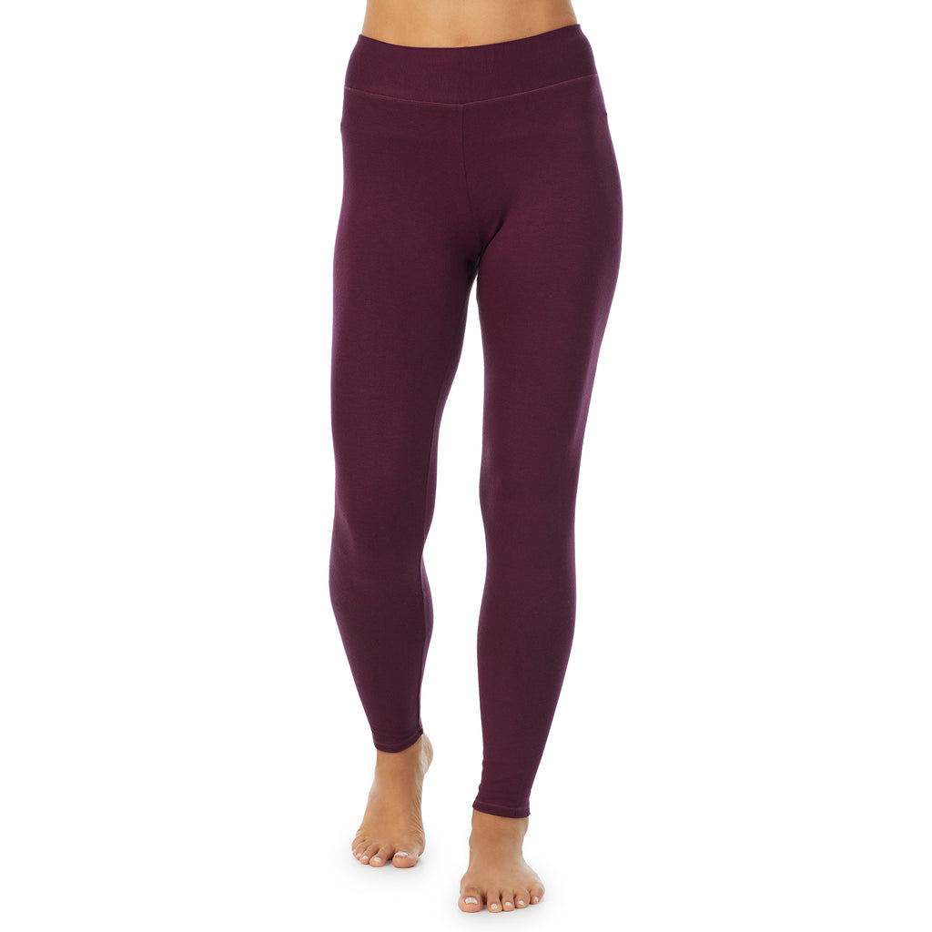 A lady wearing a Purple Beet Heather legging.