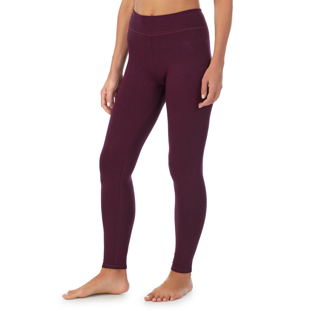 A lady wearing a Purple Beet Heather legging.