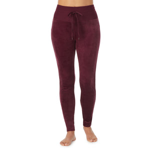 A lady wearing purple beet stretch velour legging