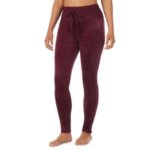 A lady wearing purple beet stretch velour legging