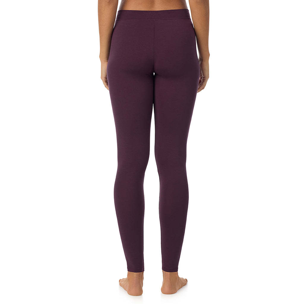 A lady wearing a boysenberry stretch legging.