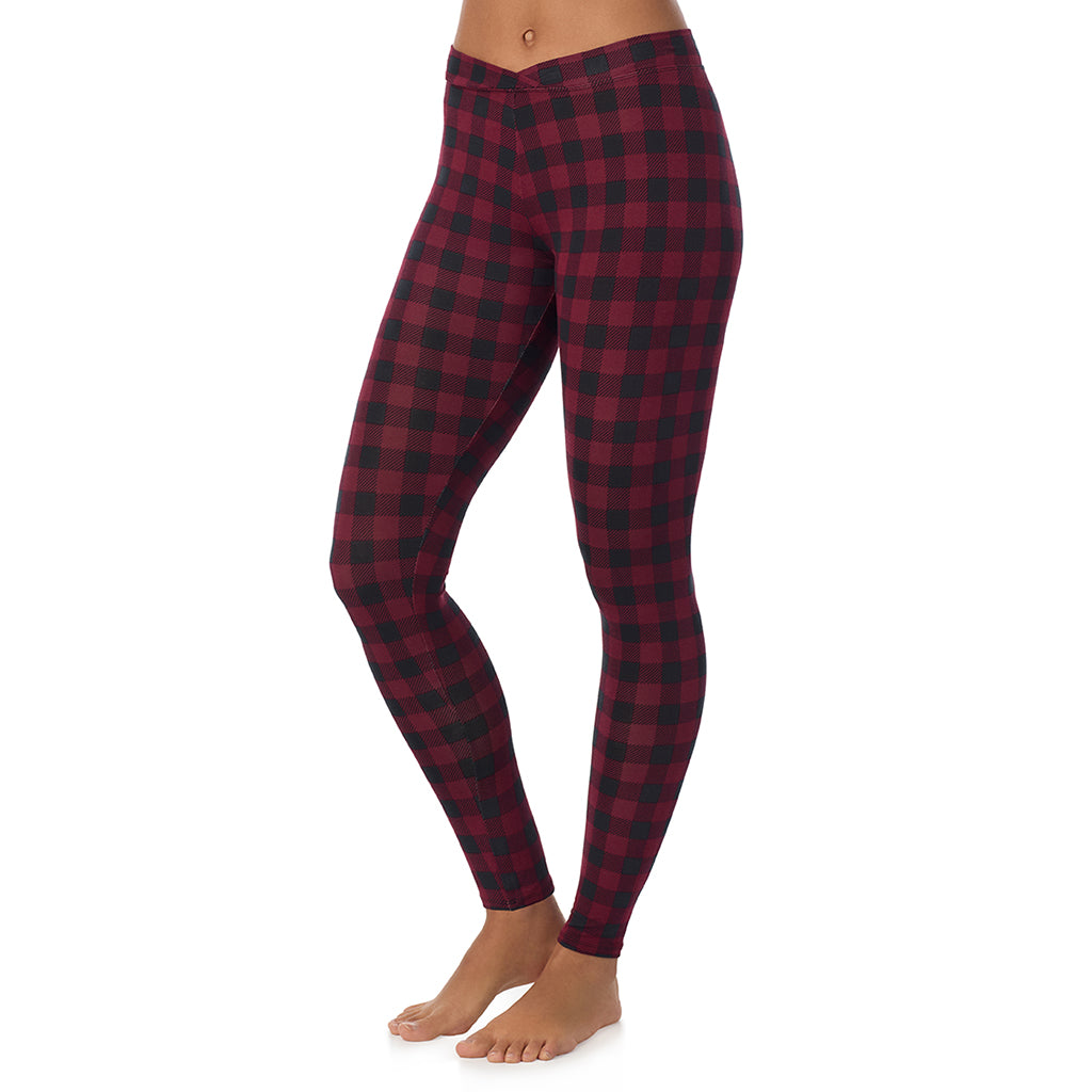 A lady wearing a cabernate buffalo check stretch legging.