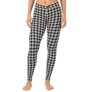 A lady wearing a ivory/black plaid stretch legging.