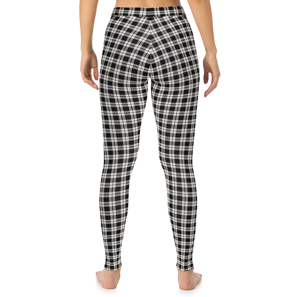 A lady wearing a ivory/black plaid stretch legging.