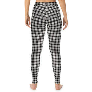 A lady wearing a ivory/black plaid stretch legging.