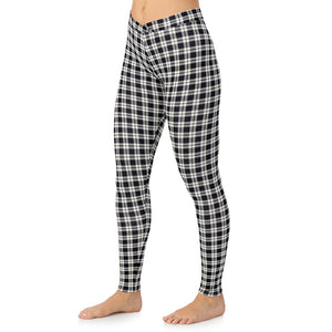 A lady wearing a ivory/black plaid stretch legging.