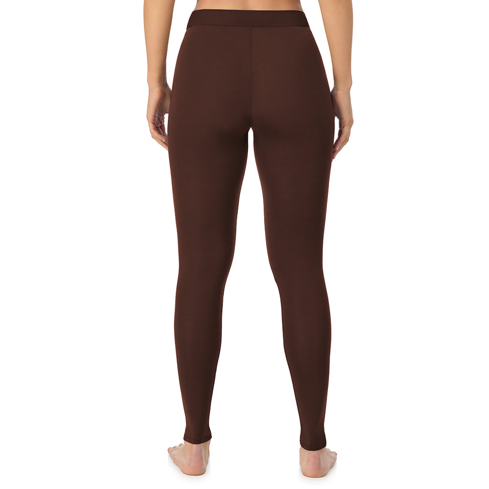 A lady wearing a deep mahogany stretch legging.