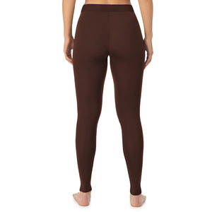 A lady wearing a deep mahogany stretch legging.