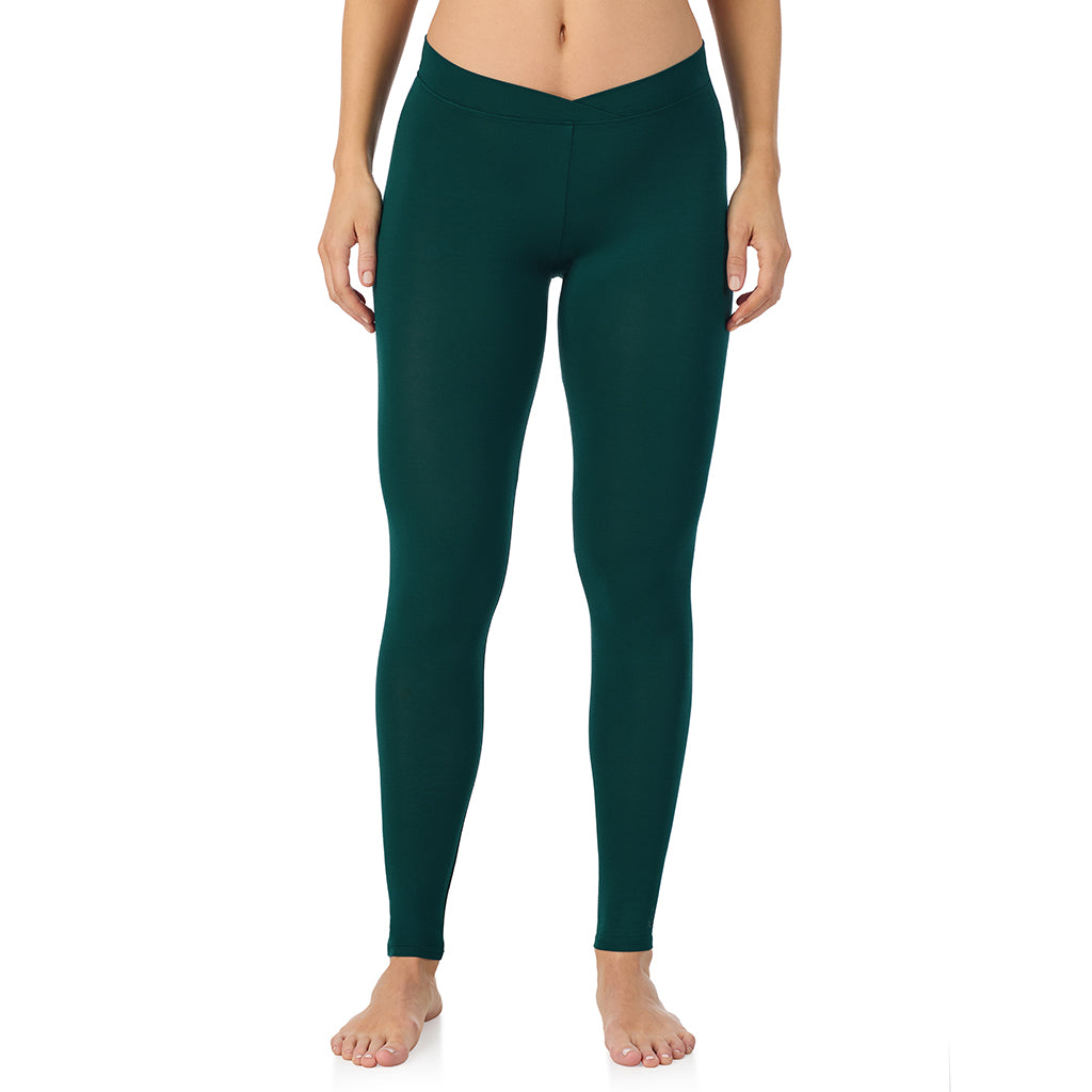 A lady wearing a dark pine stretch legging.
