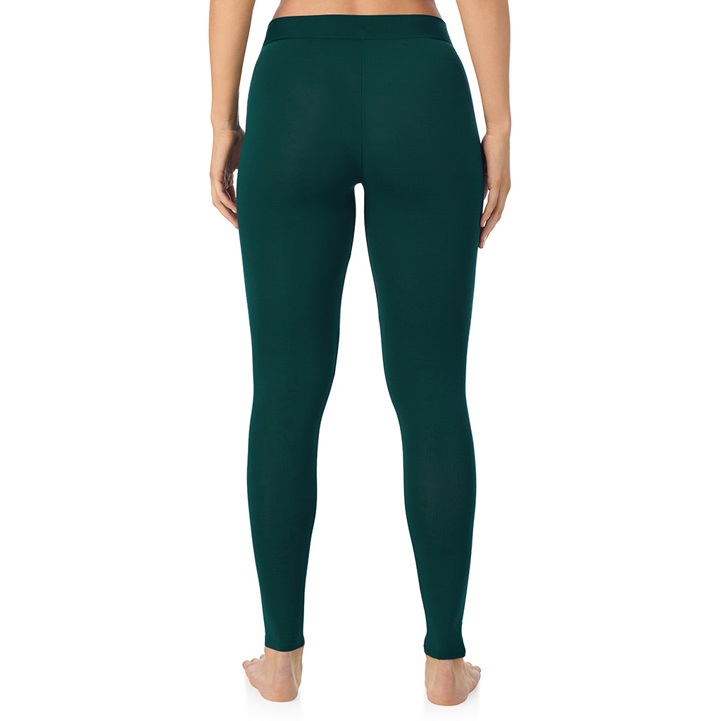 A lady wearing a dark pine stretch legging.