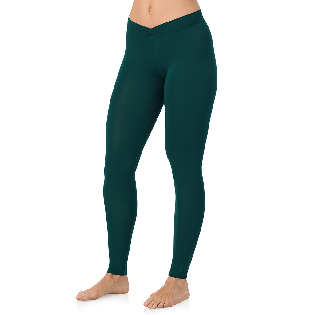 A lady wearing a dark pine stretch legging.