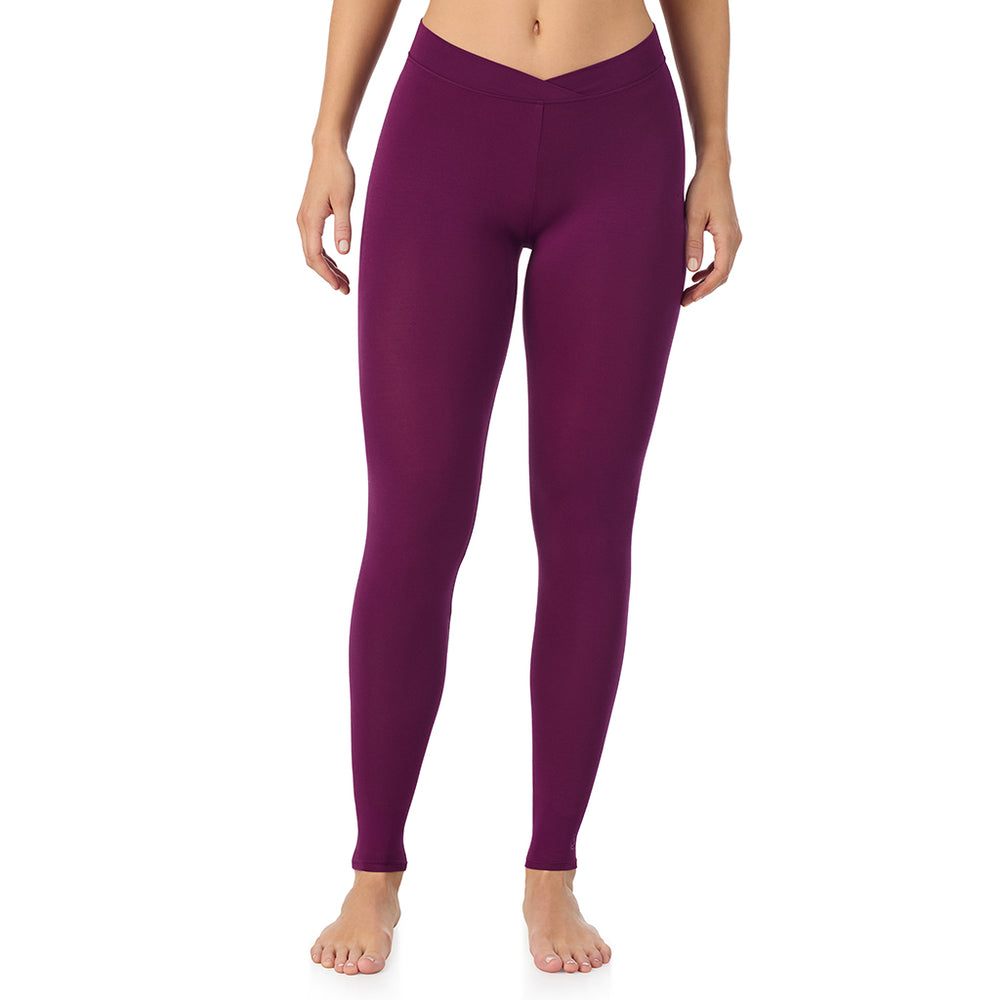 A lady wearing a dark purple stretch legging.
