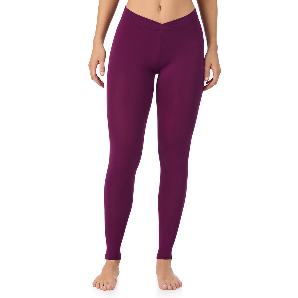 A lady wearing a dark purple stretch legging.