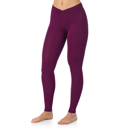 Dark Purple; Model is wearing size S. She is 5'11.5", Bust 34", Waist 26", Hips 37". @A lady wearing a dark purple stretch legging.