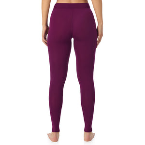 A lady wearing a dark purple stretch legging.