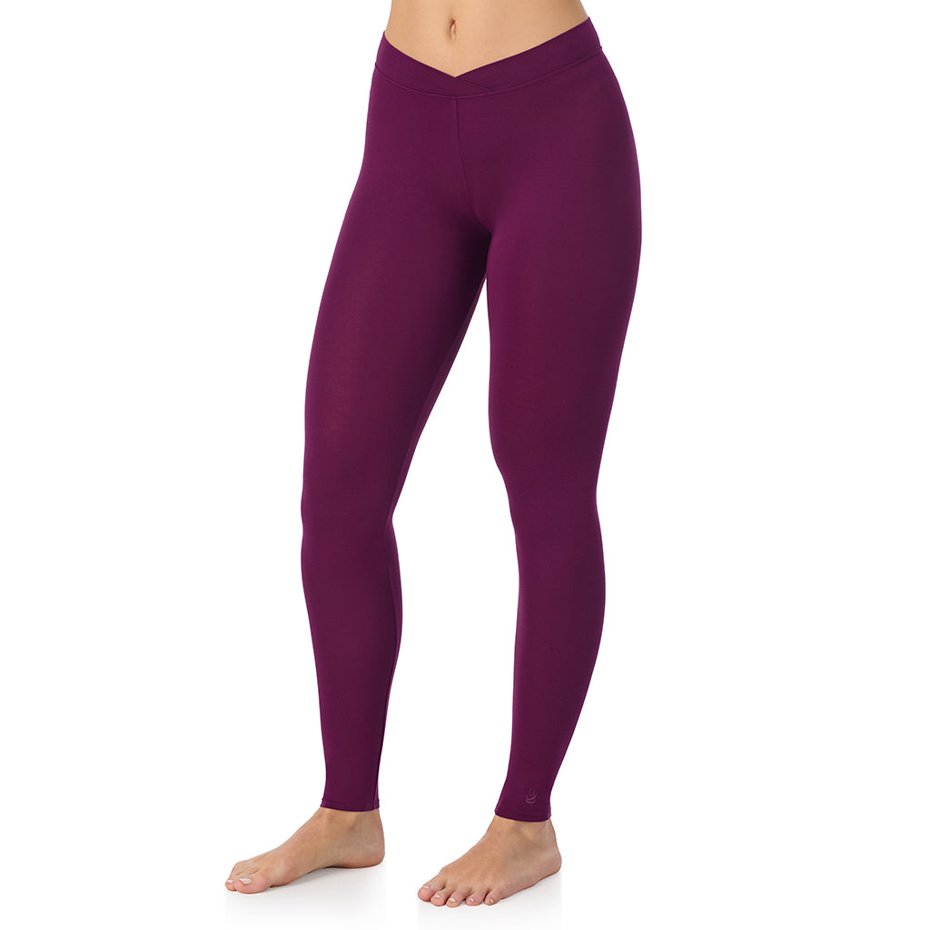A lady wearing a dark purple stretch legging.