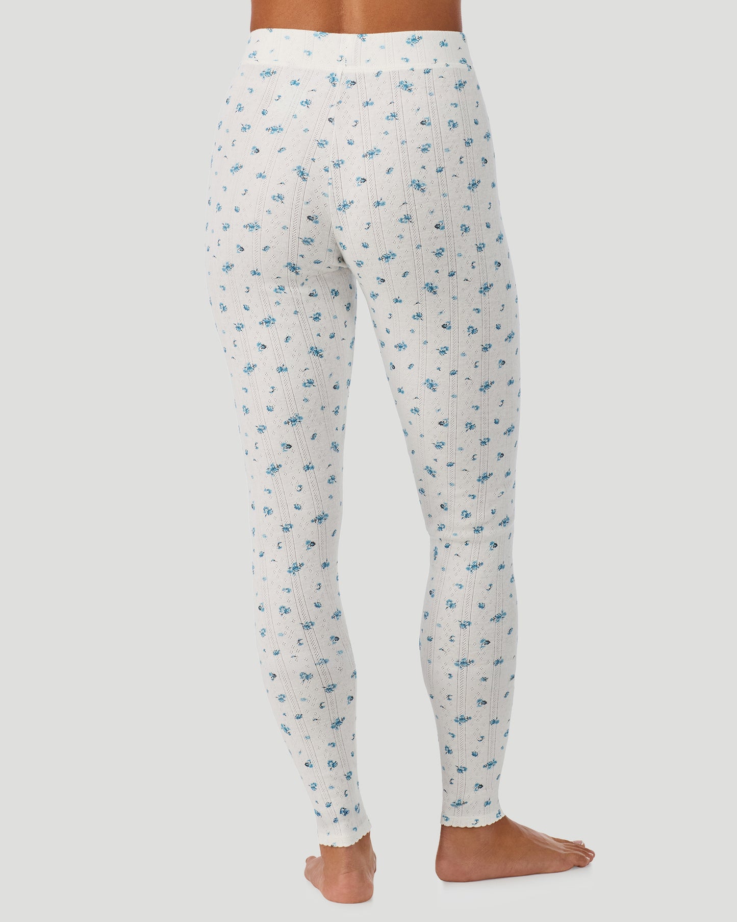 Blue Ditsy; Model is wearing a size S. She is 5’7”, Bust 32”, Waist 25”, Hips 34”. @A lady is wearing Blue Ditsy Cotton Pointelle Legging in a back view look