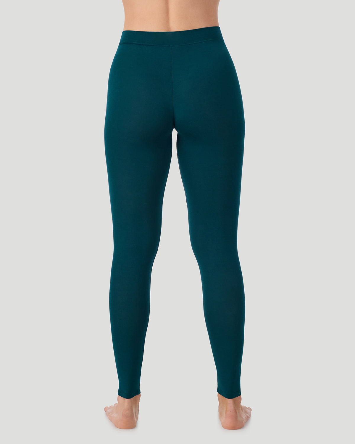 Deep Emerald ; Model is wearing a size S. She is 5’11.5”, Bust 34”, Waist 27”, Hips 38.5”.  @ A lady wearing a Deep Emerald Softwear With Stretch Legging in a back view pose