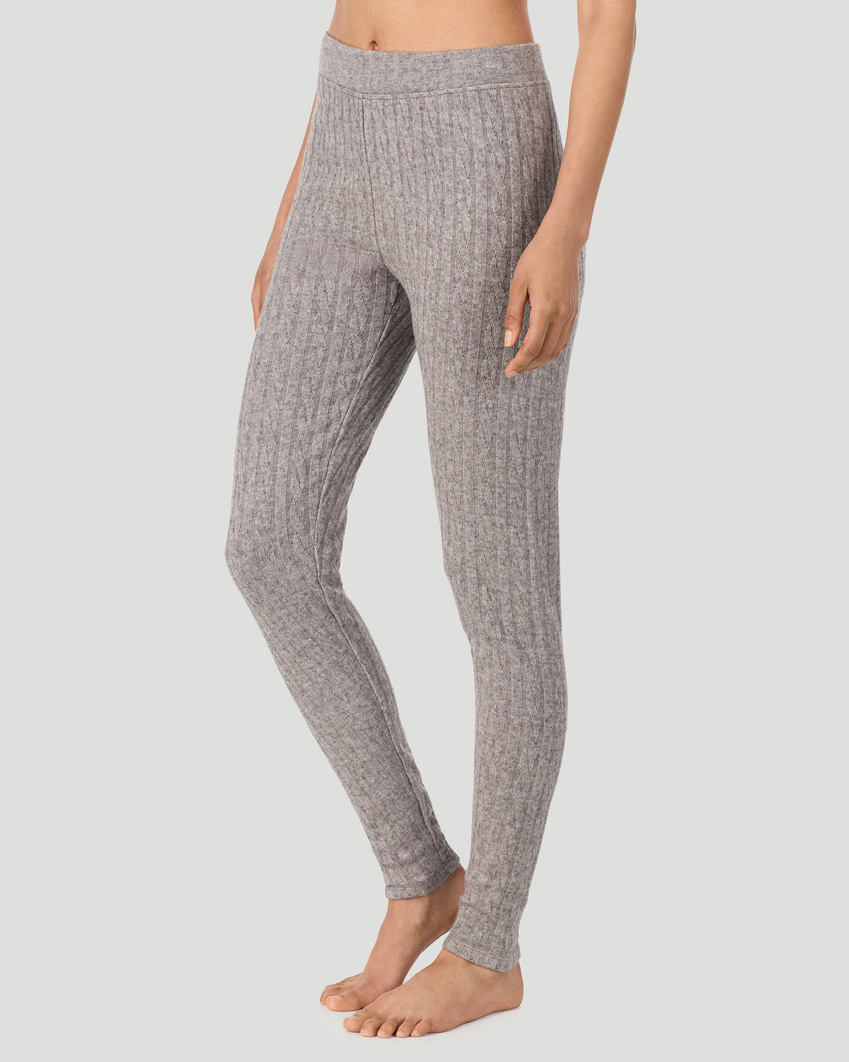 Light Grey Heather; Model is wearing a size S. She is 5’10”, Bust 33.5”, Waist 25”, Hips 36”. @A lady wearing Light Grey Heather Cable Knit Legging in a front view side angle pose