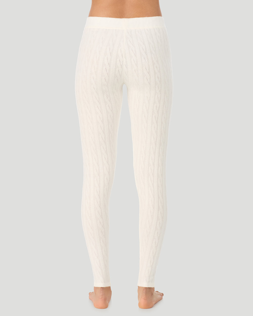 A lady wearing Vanilla Ice Cable Knit Legging in a back view pose