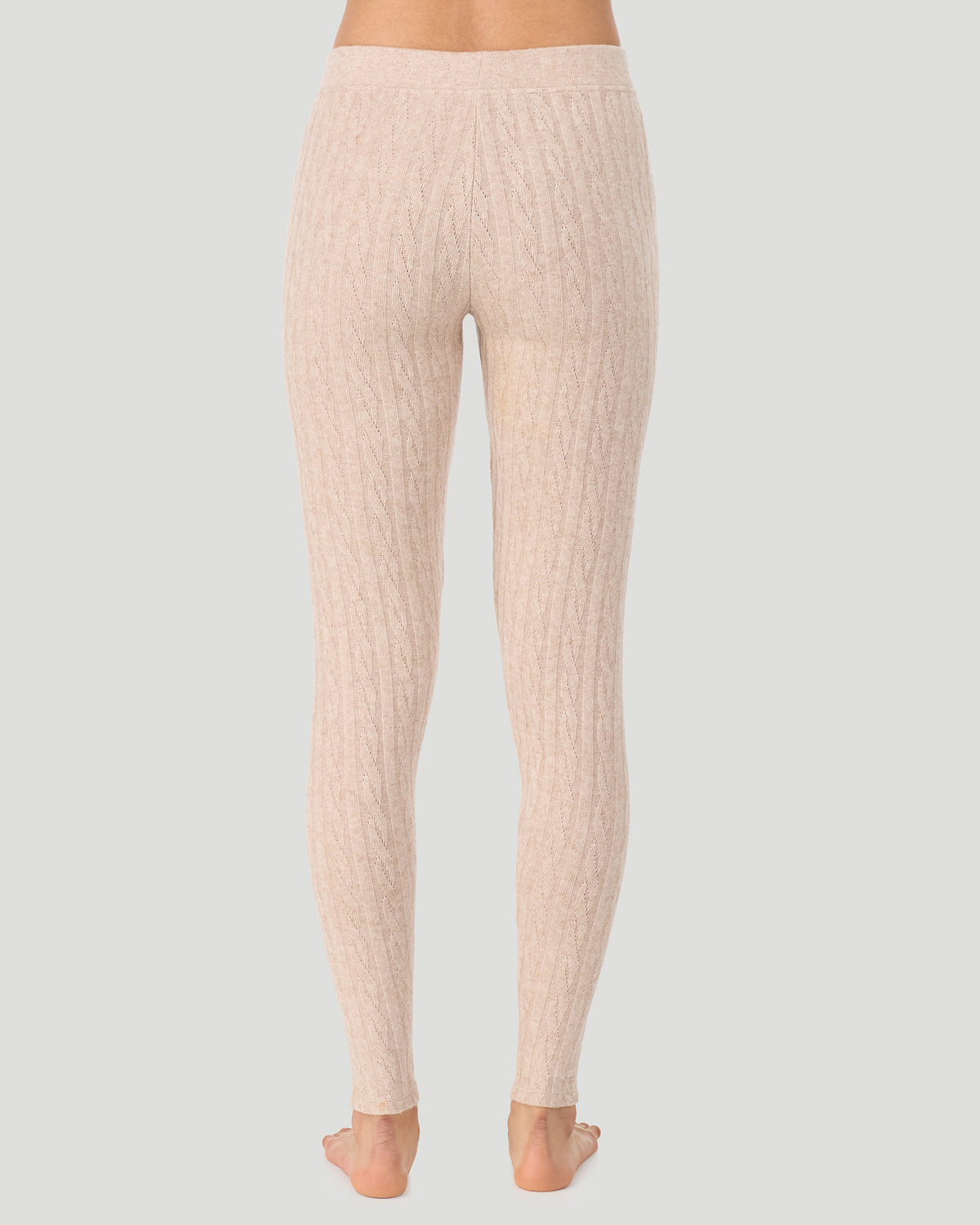 A lady wearing Oatmeal Heather Cable Knit Legging in a back view pose
