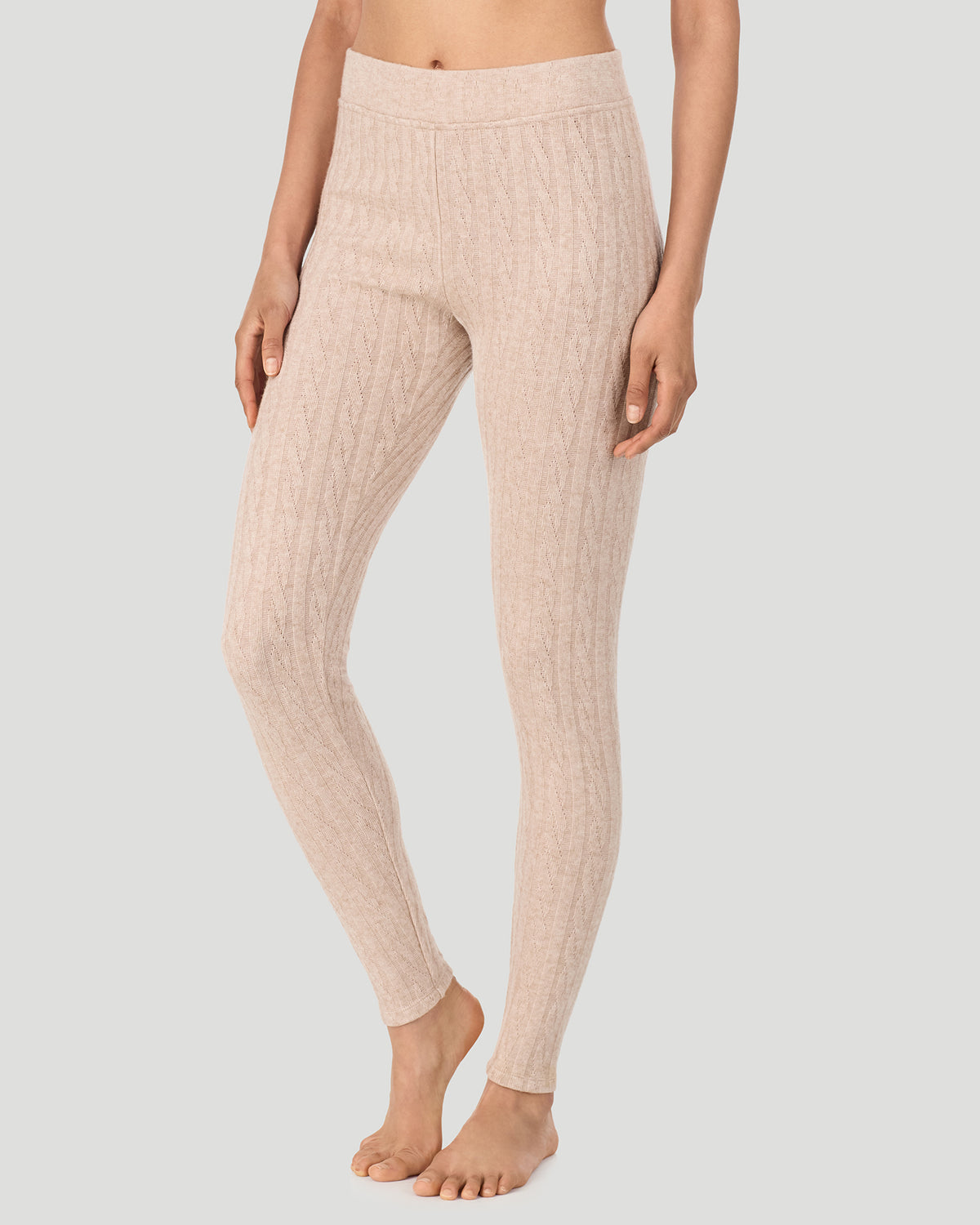 Oatmeal Heather; Model is wearing a size S. She is 5’10”, Bust 33.5”, Waist 25”, Hips 36”. @A lady wearing Oatmeal Heather Cable Knit Legging in a front view side angle pose