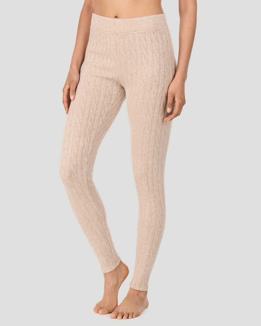 A lady wearing Oatmeal Heather Cable Knit Legging in a front view side angle pose