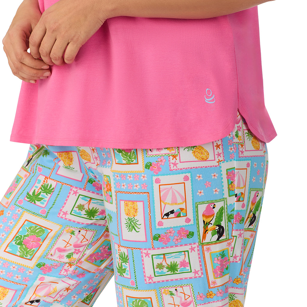 Summer Frame; Model is wearing size 1X. She is 5'11.5", Bust 41", Waist 33", Hips 46" @A lady wearing pink short sleeve top with cropped pant pajama set with summer frame print