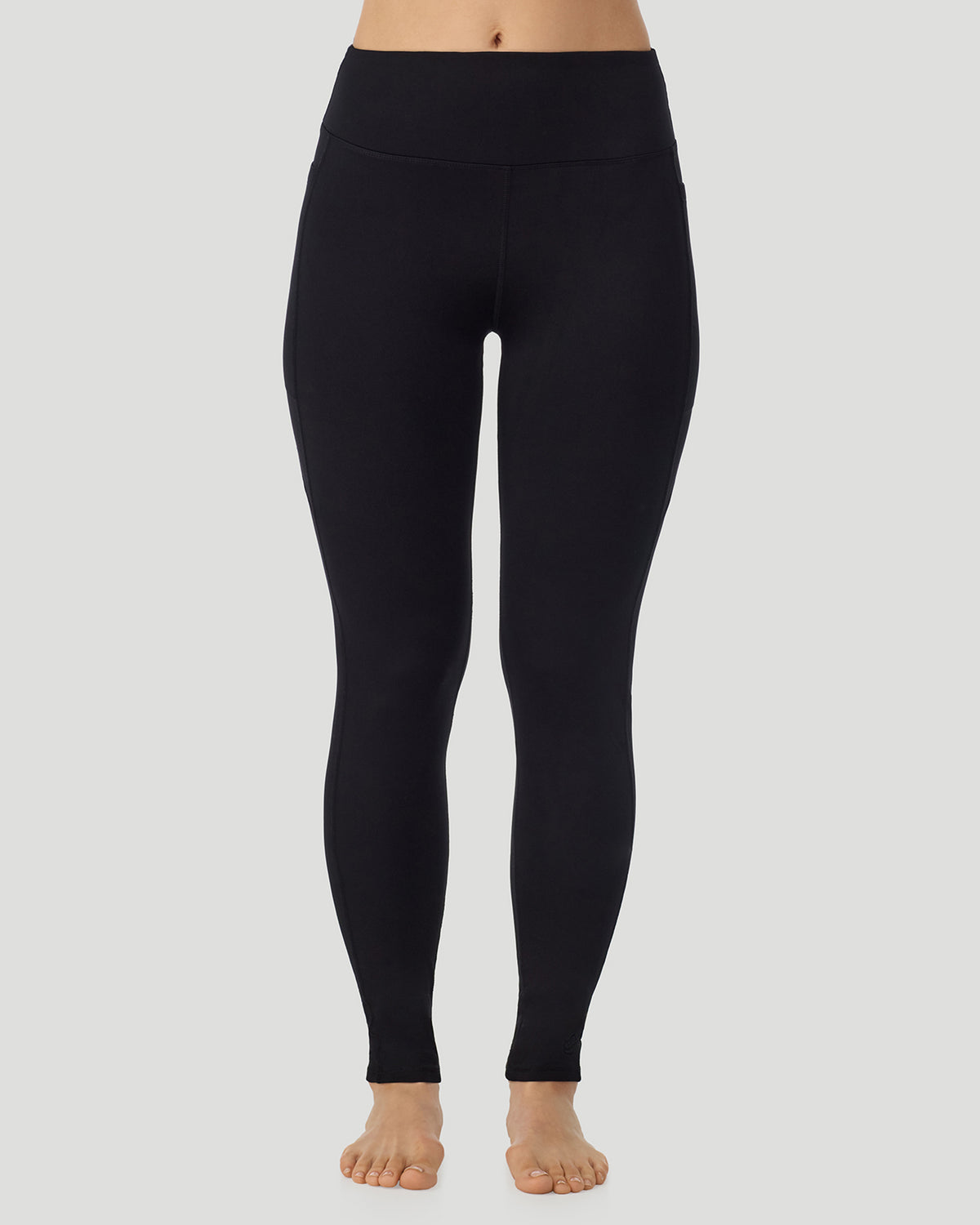 A lady wearing Thermawear Hi-Waisted Legging With Pockets in black shown in a front view pose