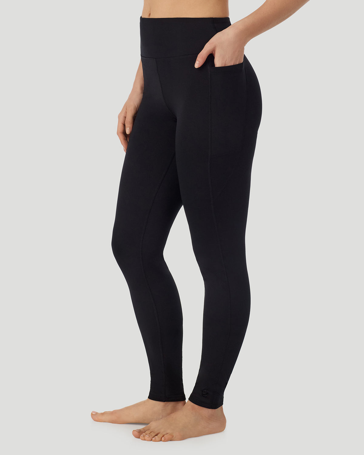 Black; Model is wearing a size S. She is 5’9.5”, Bust 34”, Waist 25”, Hips 36.5”. @A lady wearing Thermawear Hi-Waisted Legging With Pockets in black shown in a front side angle  pose while placing her hand inside the pocket