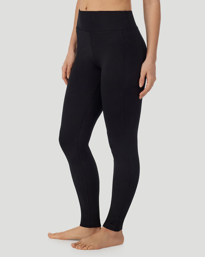 A lady wearing Thermawear Hi-Waisted Legging With Pockets in black shown in a front view side angle pose