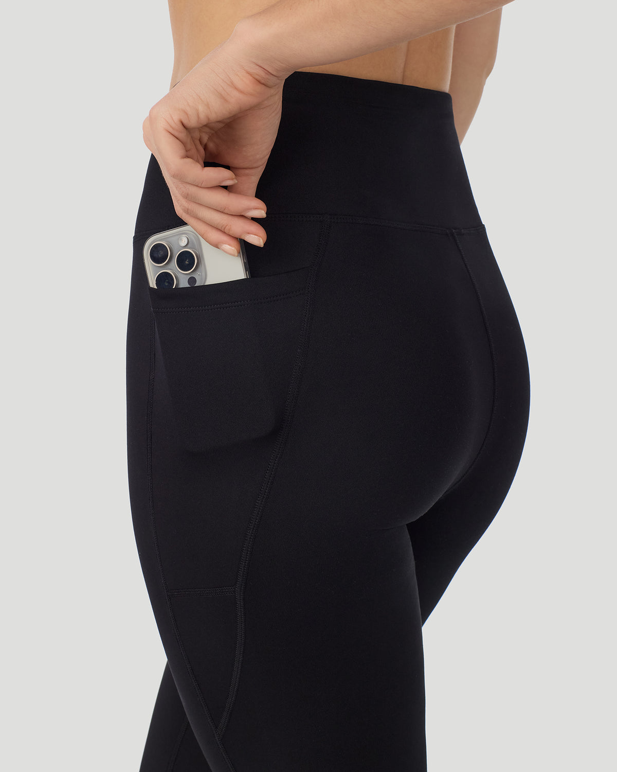 Black; Model is wearing a size S. She is 5’9.5”, Bust 34”, Waist 25”, Hips 36.5”. @A lady wearing Thermawear Hi-Waisted Legging With Pockets in black shown in a side angle detail close up view