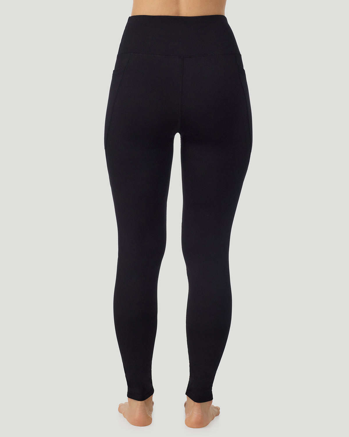 Black; Model is wearing a size S. She is 5’9.5”, Bust 34”, Waist 25”, Hips 36.5”. @A lady wearing Thermawear Hi-Waisted Legging With Pockets in black shown in a back view pose