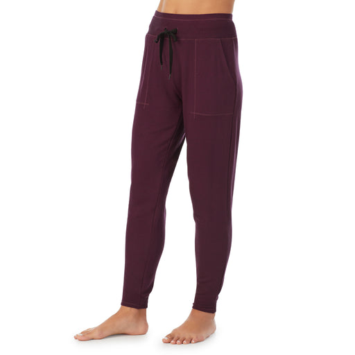 Purple Beet Heather; Model is wearing size S. She is 5’9”, Bust 34”, Waist 25.5”, Hips 36.5”. @A lady wearing a Purple Beet Heather jogger.