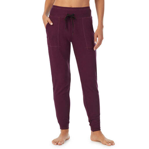 Purple Beet Heather; Model is wearing size S. She is 5’9”, Bust 34”, Waist 25.5”, Hips 36.5”. @A lady wearing a Purple Beet Heather jogger.