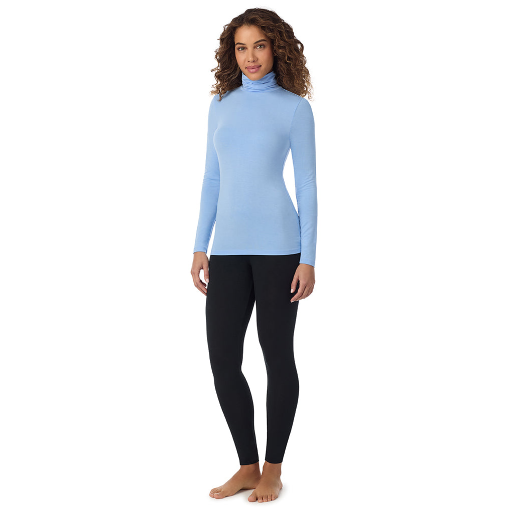 Vista Blue; Model is wearing size S. She is 5’9”, Bust 34”, Waist 23”, Hips 35”.@A lady wearing ultramarine long sleeve vista blue softwear with stretch top.