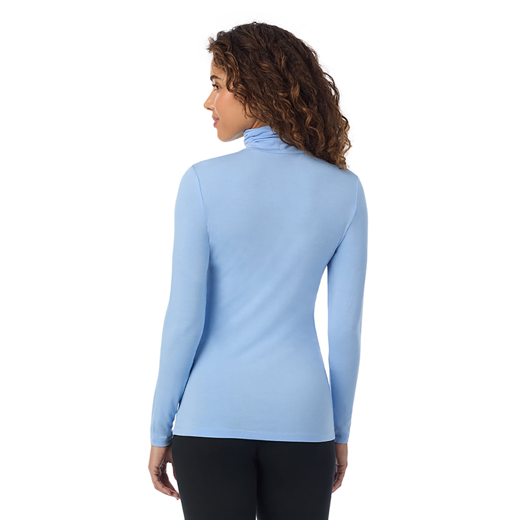 Vista Blue; Model is wearing size S. She is 5’9”, Bust 34”, Waist 23”, Hips 35”.@A lady wearing ultramarine long sleeve vista blue softwear with stretch top.