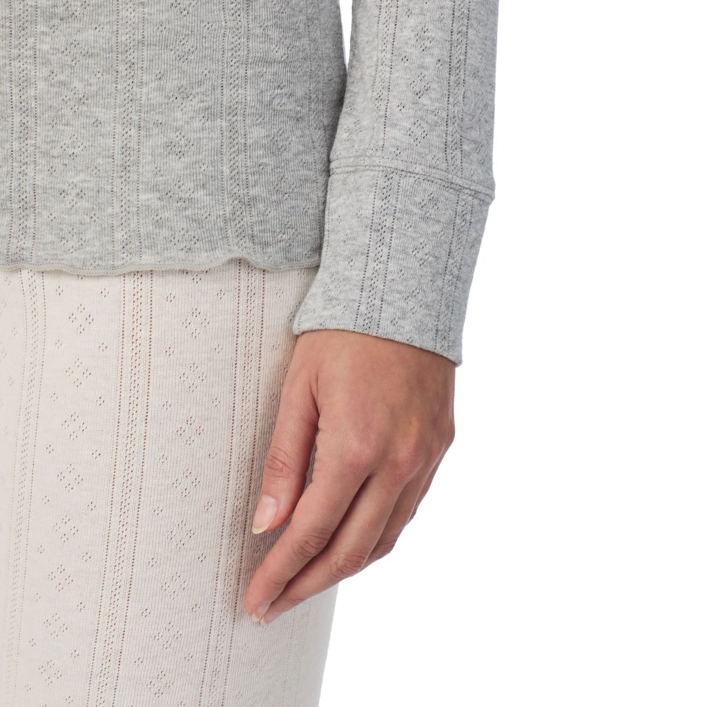 A lady is wearing Cotton Pointelle Long Sleeve Henley
