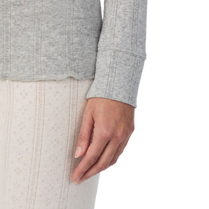 A lady is wearing Cotton Pointelle Long Sleeve Henley
